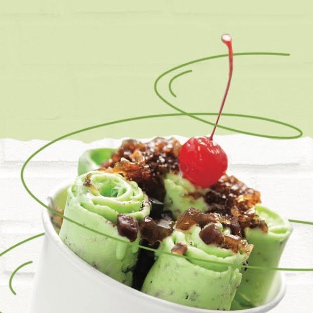 Mint chocolate chip ice cream rolls topped with a cherry